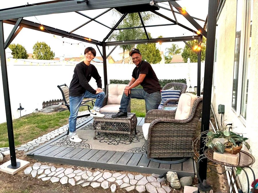 Host and student relaxing in backyard gazebo