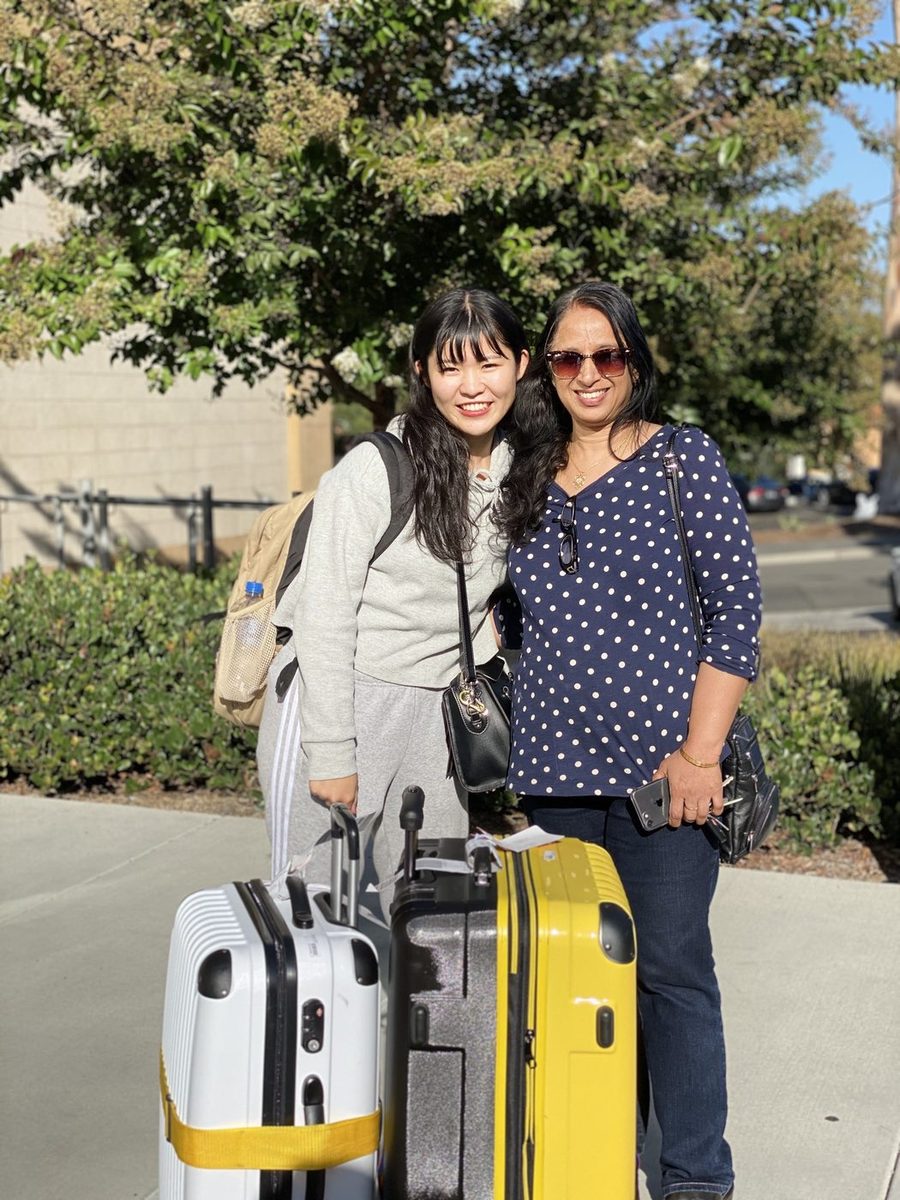 Host welcoming student with luggage on arrival day