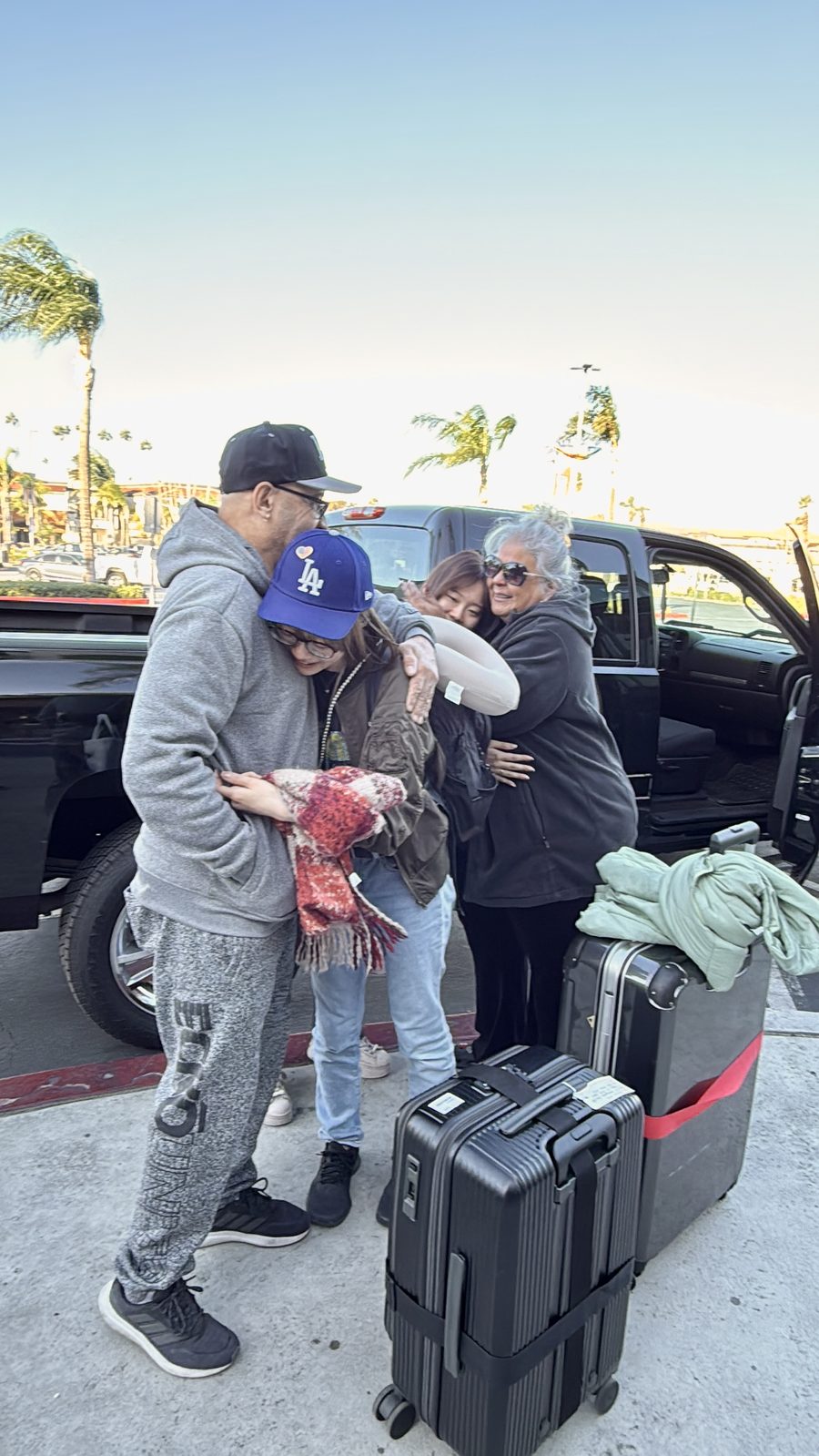 Host family and students hugging goodbye on departure day